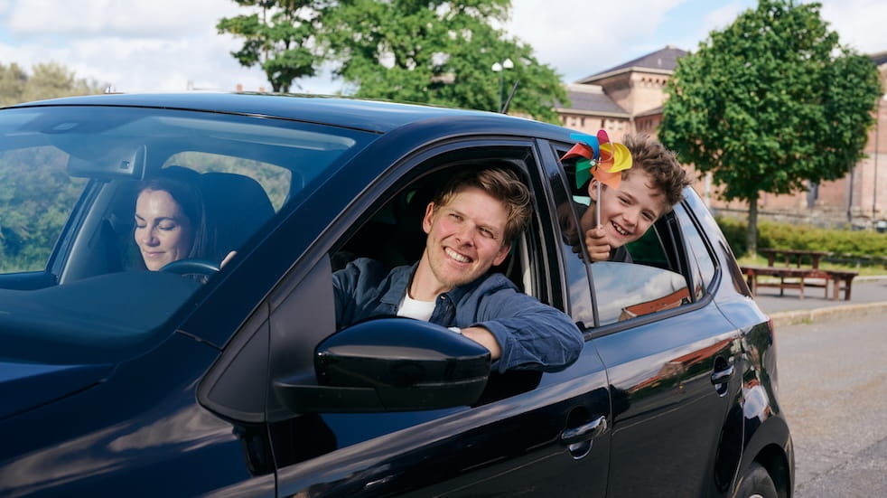 Family heading off on holiday in their car